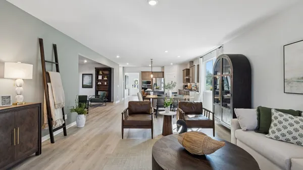 a kitchen with stainless steel appliances a dining table chairs stove and refrigerator