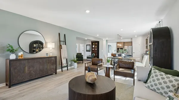 a kitchen with stainless steel appliances granite countertop a table chairs stove and refrigerator