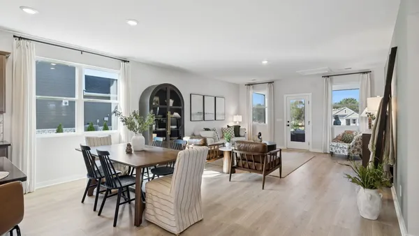 a kitchen with stainless steel appliances granite countertop a stove a sink a dining table and chairs