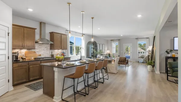 a living room with furniture a flat screen tv and a window