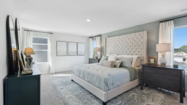 a view of a large pool with lawn chairs and a big yard