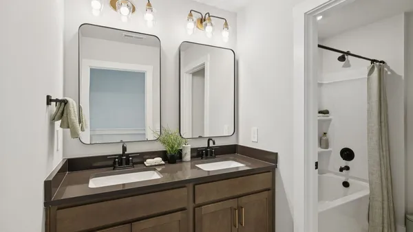 a view of a garden with lawn chairs and plants