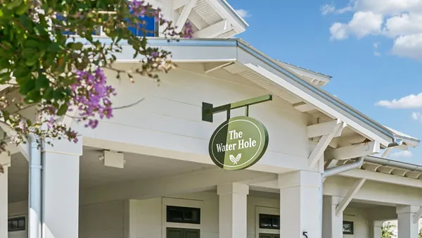 an aerial view of residential building and lake