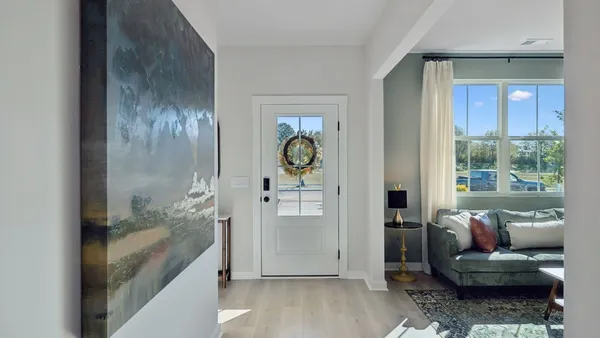 a kitchen with stainless steel appliances a sink a stove a refrigerator and chairs