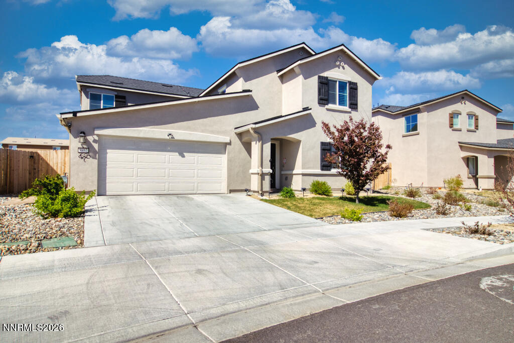8957 Buffalo Grove Drive Reno, NV 89506 - Photo 2 of 59 a front view of a house with a yard and garage