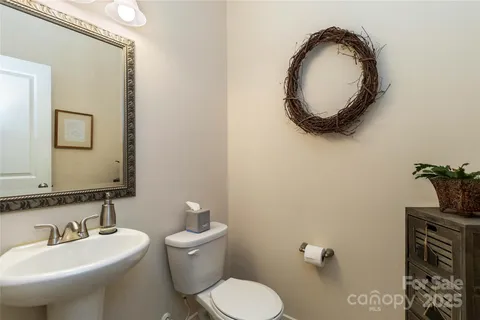 a bathroom with a toilet a sink and mirror
