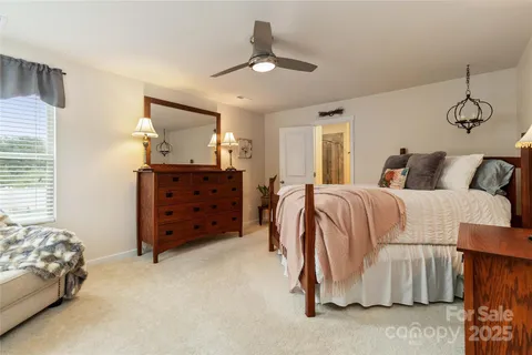 a bed room with a bed and a chair