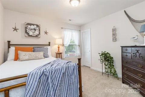 a bedroom with a bed and a dresser in it