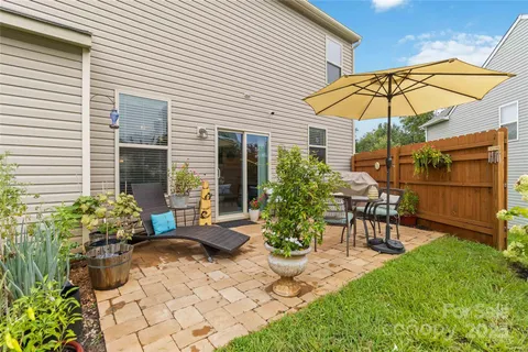 a view of a chair and table in backyard