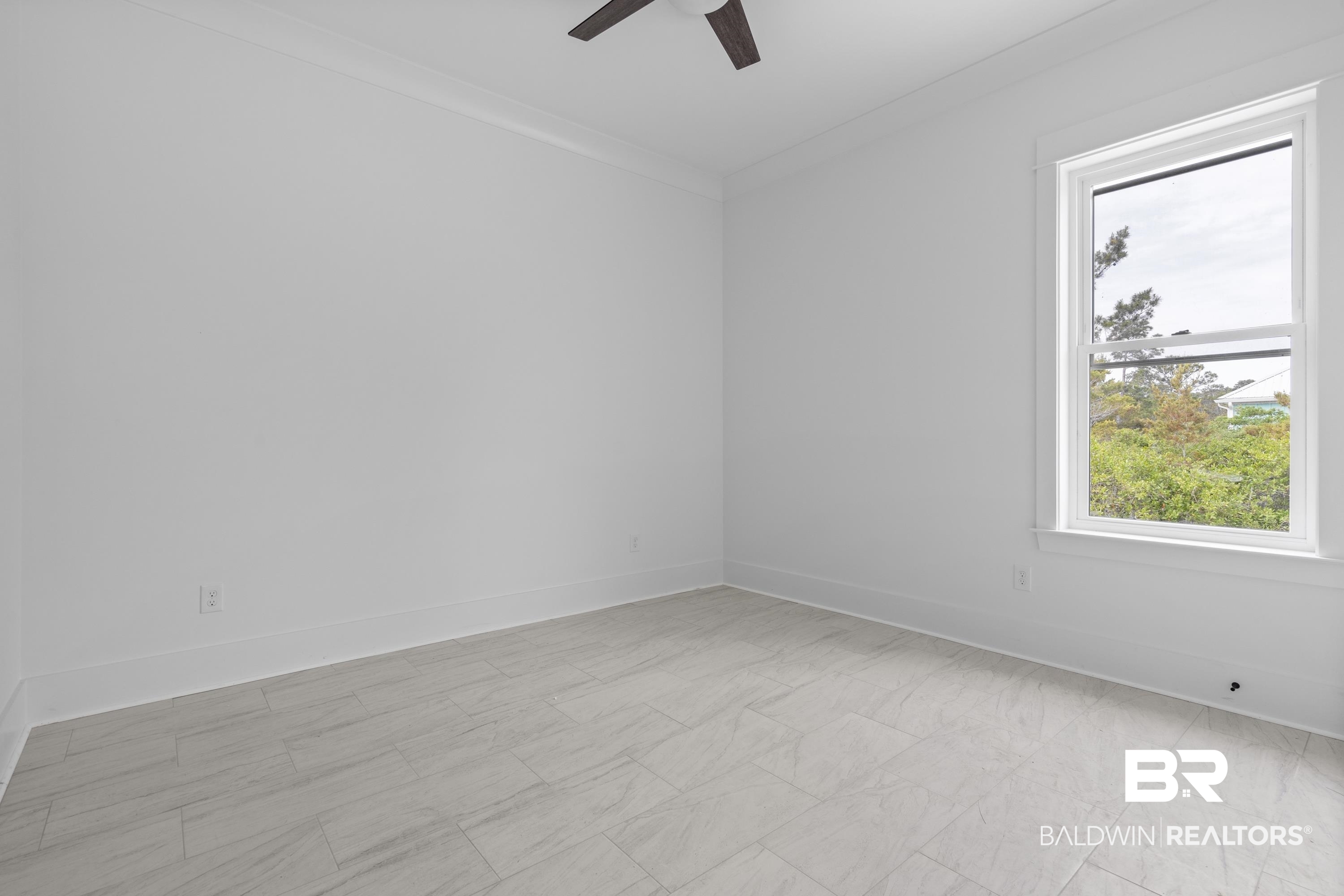 30650 Ono N Loop West Orange Beach, AL 36561 - Photo 24 of 38 Spare room featuring a ceiling fan, healthy amount of natural light, and baseboards