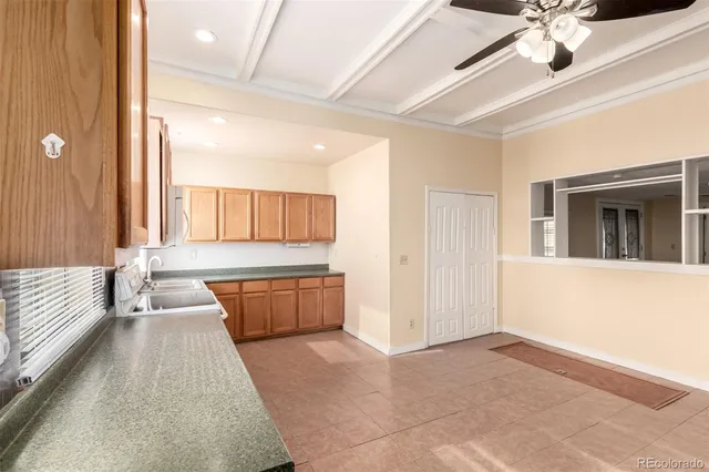 a large white kitchen with a large window