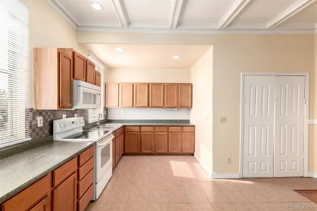 a large kitchen with a sink and cabinets