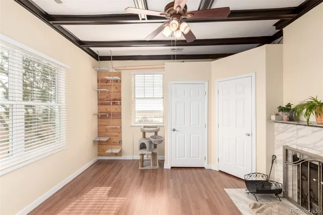 a view of empty room with wooden floor and fireplace