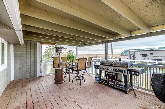 a view of a chairs and table on the deck