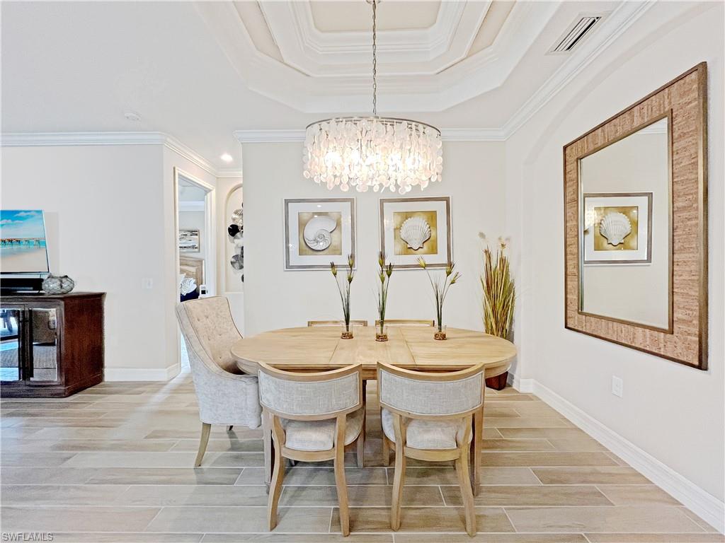 1975 Mustique Street Naples, FL 34120 - Photo 11 of 42 a view of a dining room with furniture window and wooden floor