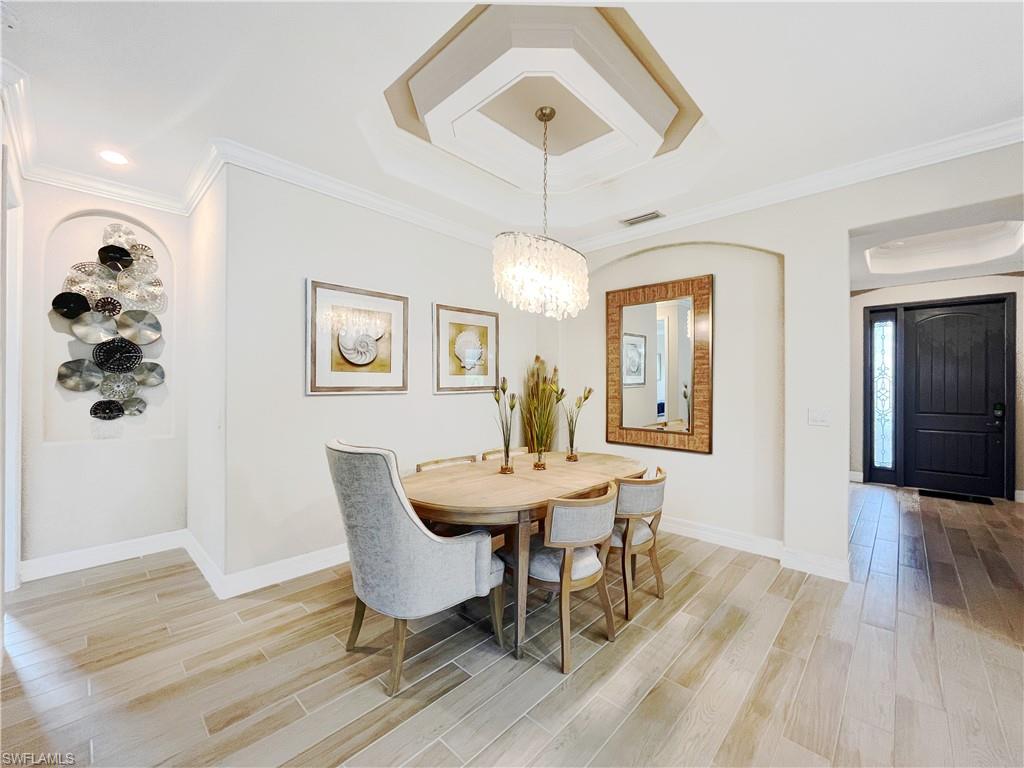1975 Mustique Street Naples, FL 34120 - Photo 12 of 42 a view of a dining room with furniture window and wooden floor