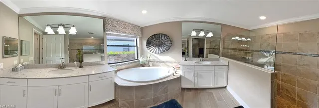 a bathroom with a double vanity sink and a mirror
