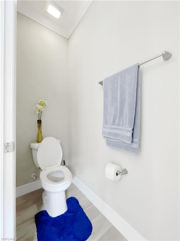 1975 Mustique Street Naples, FL 34120 - Photo 28 of 42 a white toilet sitting next to a bathroom sink