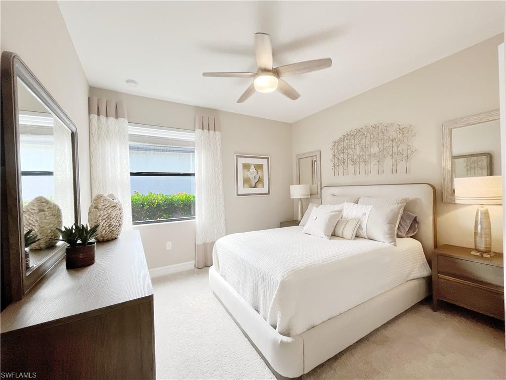 1975 Mustique Street Naples, FL 34120 - Photo 30 of 42 a bedroom with a large bed and a large window with the outer view