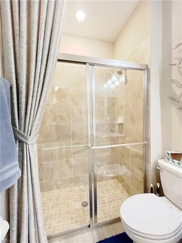 a bathroom with a toilet and a shower