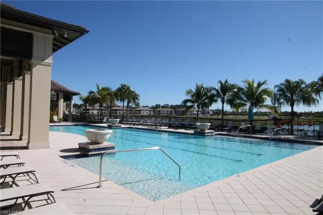 a view of swimming pool with outdoor seating and plants