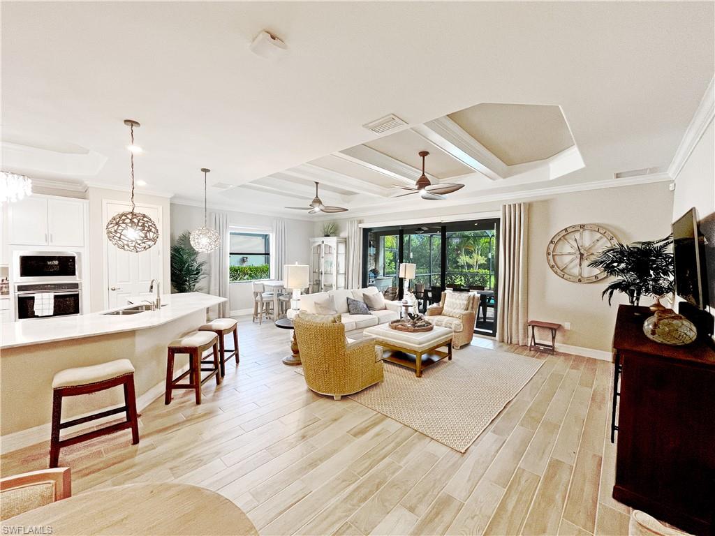 1975 Mustique Street Naples, FL 34120 - Photo 7 of 42 a living room with furniture and a wooden floor
