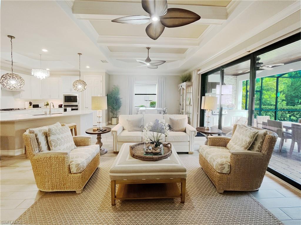1975 Mustique Street Naples, FL 34120 - Photo 8 of 42 a living room with furniture ceiling fan and a large window
