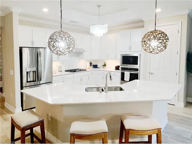 a large kitchen with a table and chairs