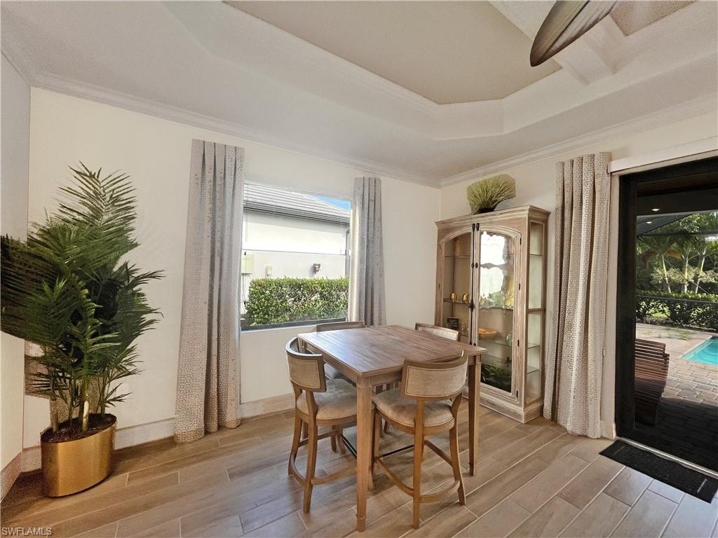 1975 Mustique Street Naples, FL 34120 - Photo 10 of 42 a view of a dining room with furniture window and wooden floor