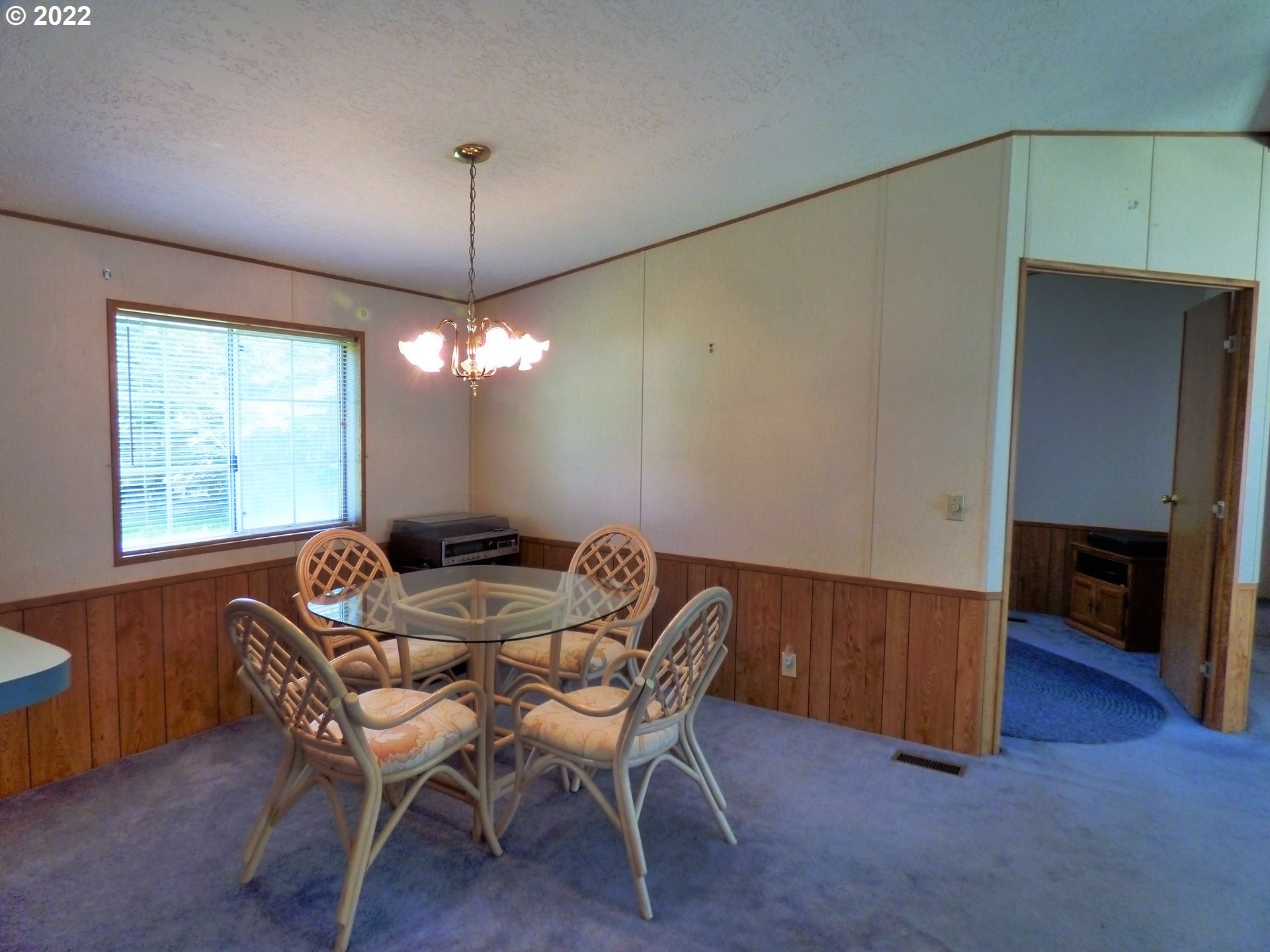 59254 Seven Devils Road Bandon, OR 97411 - Photo 17 of 31 a view of a dining room with furniture window and wooden floor