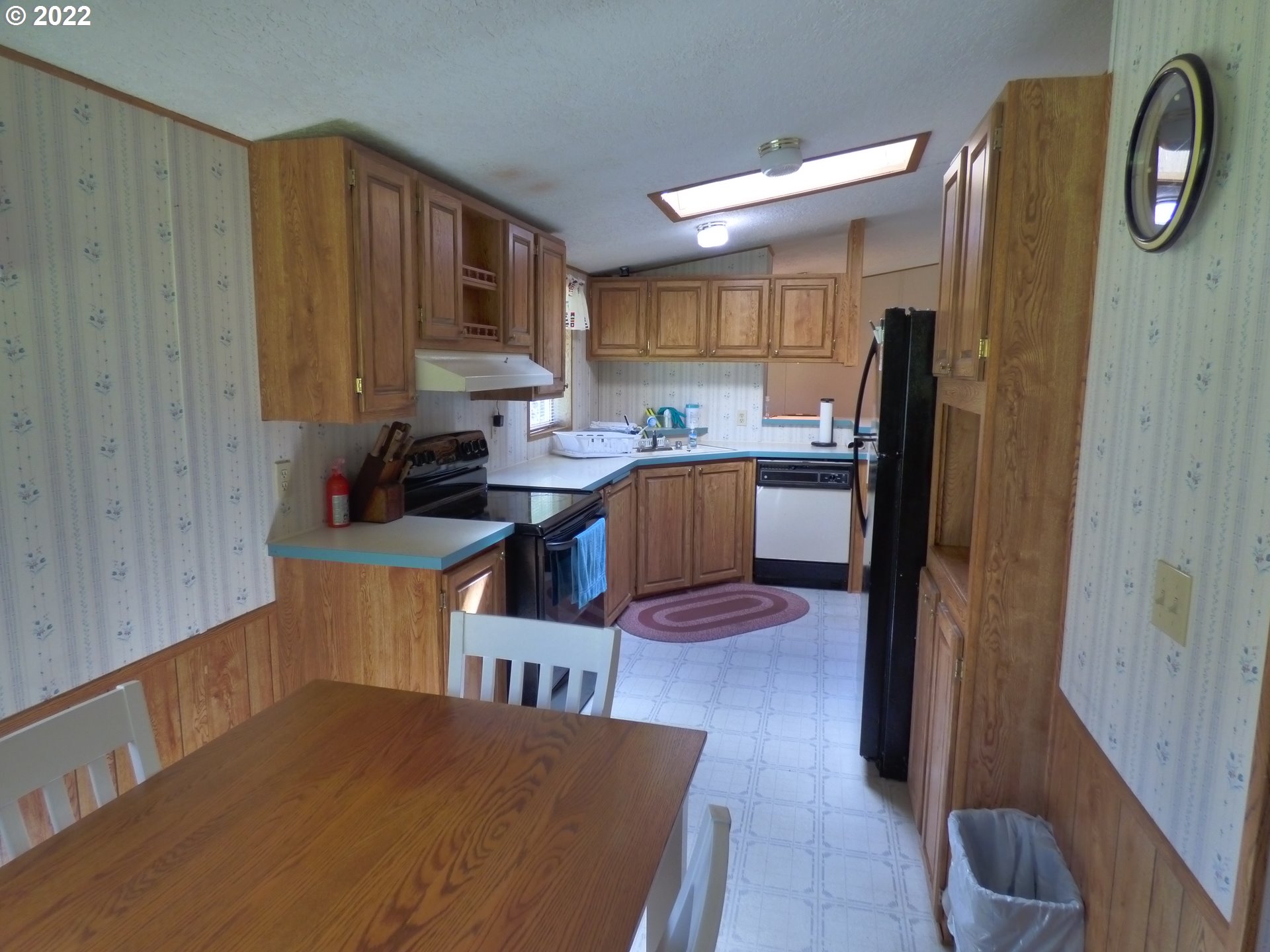 59254 Seven Devils Road Bandon, OR 97411 - Photo 18 of 31 a kitchen with stainless steel appliances granite countertop a refrigerator a sink a stove and a wooden cabinets