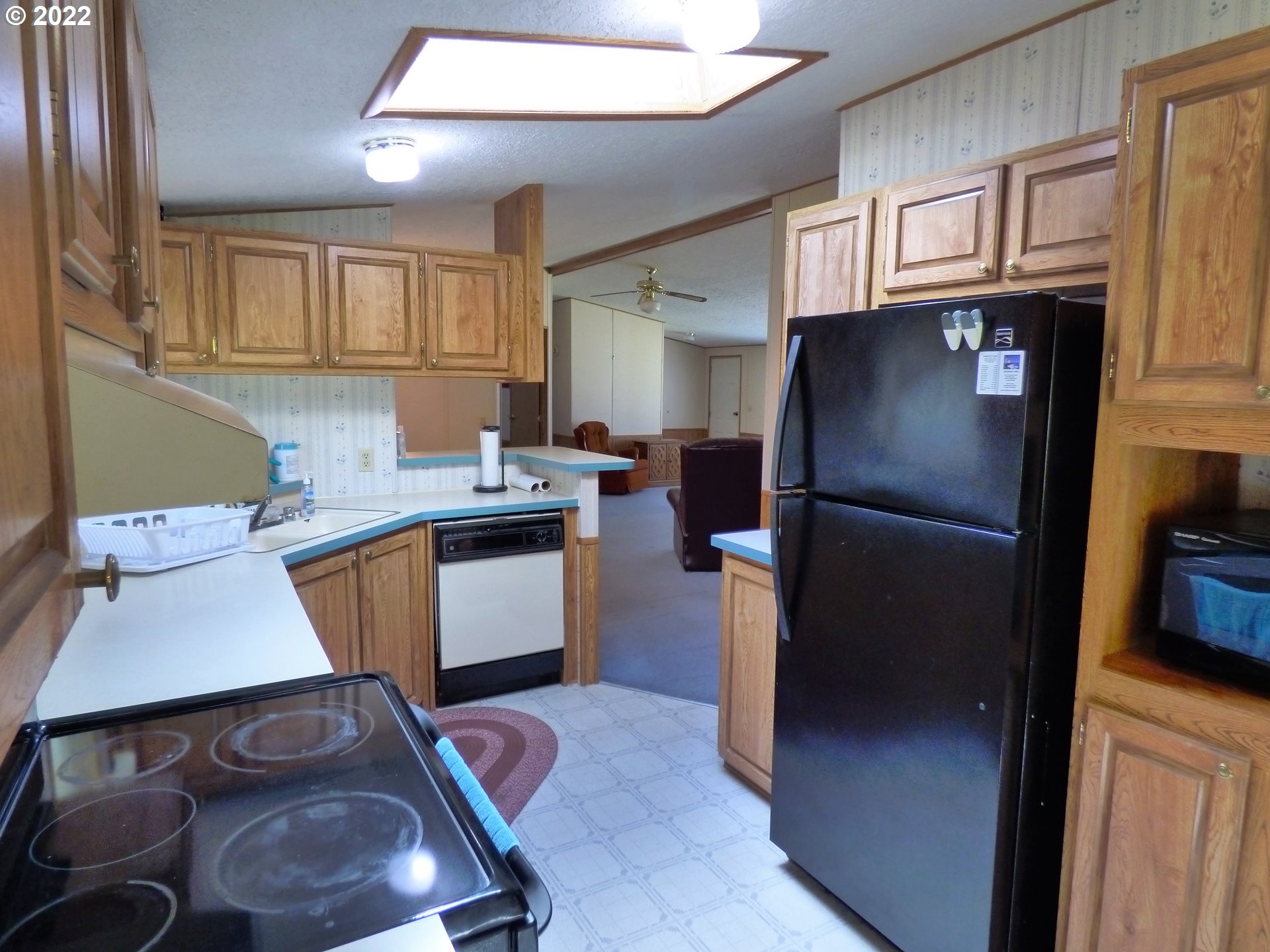 59254 Seven Devils Road Bandon, OR 97411 - Photo 19 of 31 a kitchen with stainless steel appliances granite countertop a refrigerator stove and sink