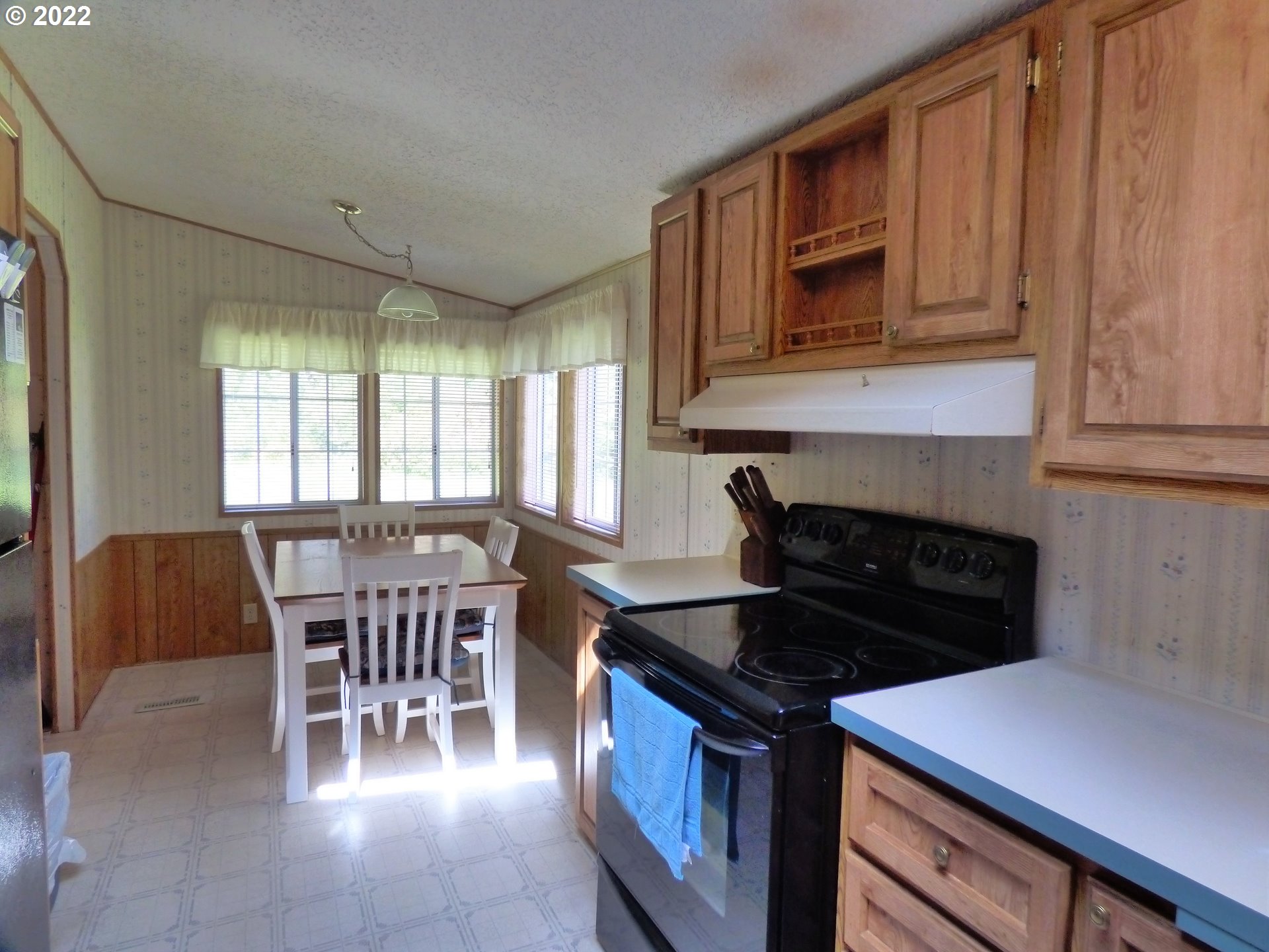 59254 Seven Devils Road Bandon, OR 97411 - Photo 22 of 31 a kitchen with a stove and chairs