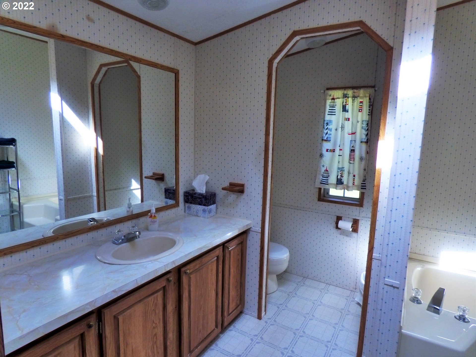 59254 Seven Devils Road Bandon, OR 97411 - Photo 26 of 31 a bathroom with a sink a toilet and mirror