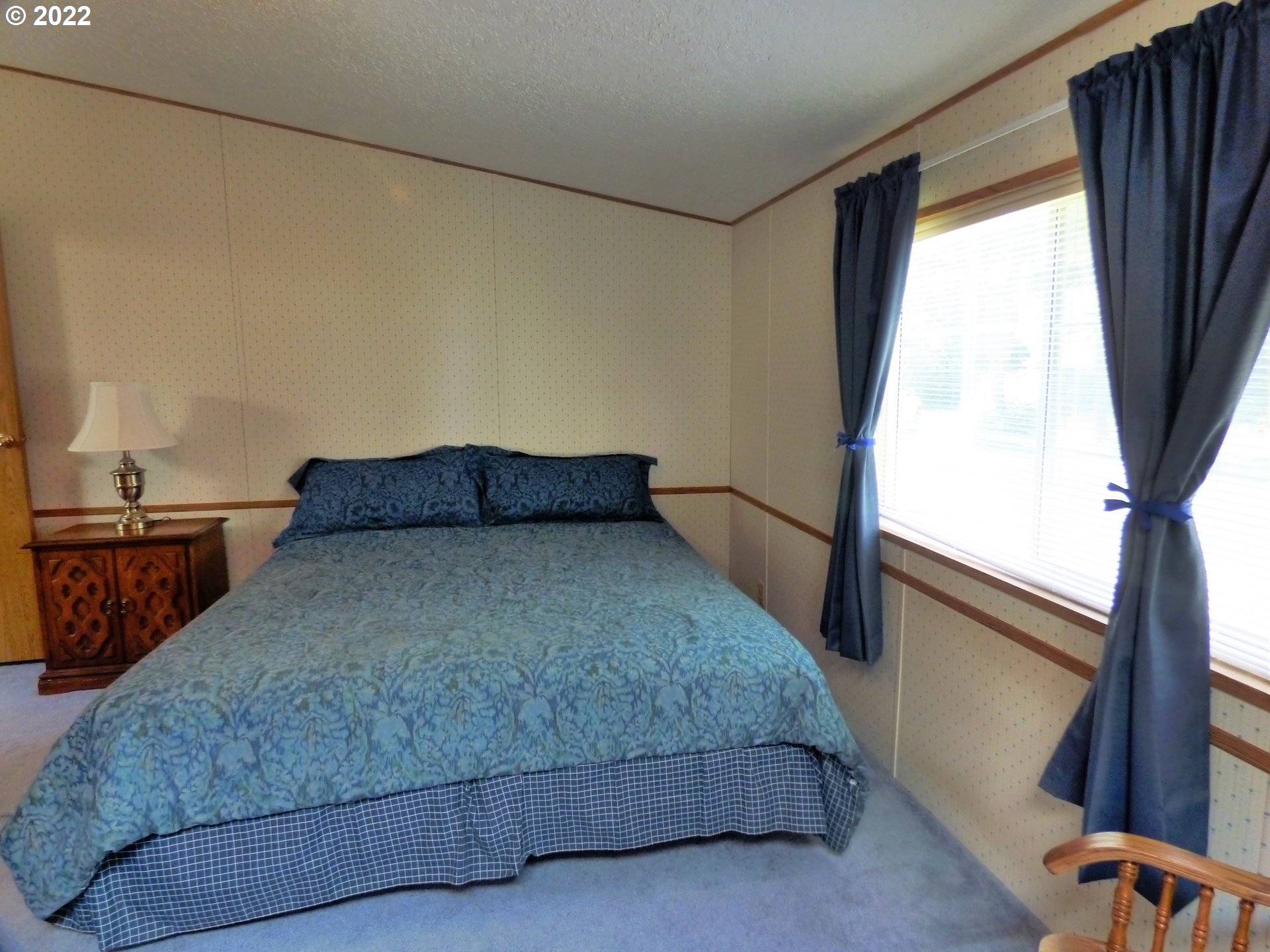 59254 Seven Devils Road Bandon, OR 97411 - Photo 29 of 31 a bedroom with a bed and a window with the outer view