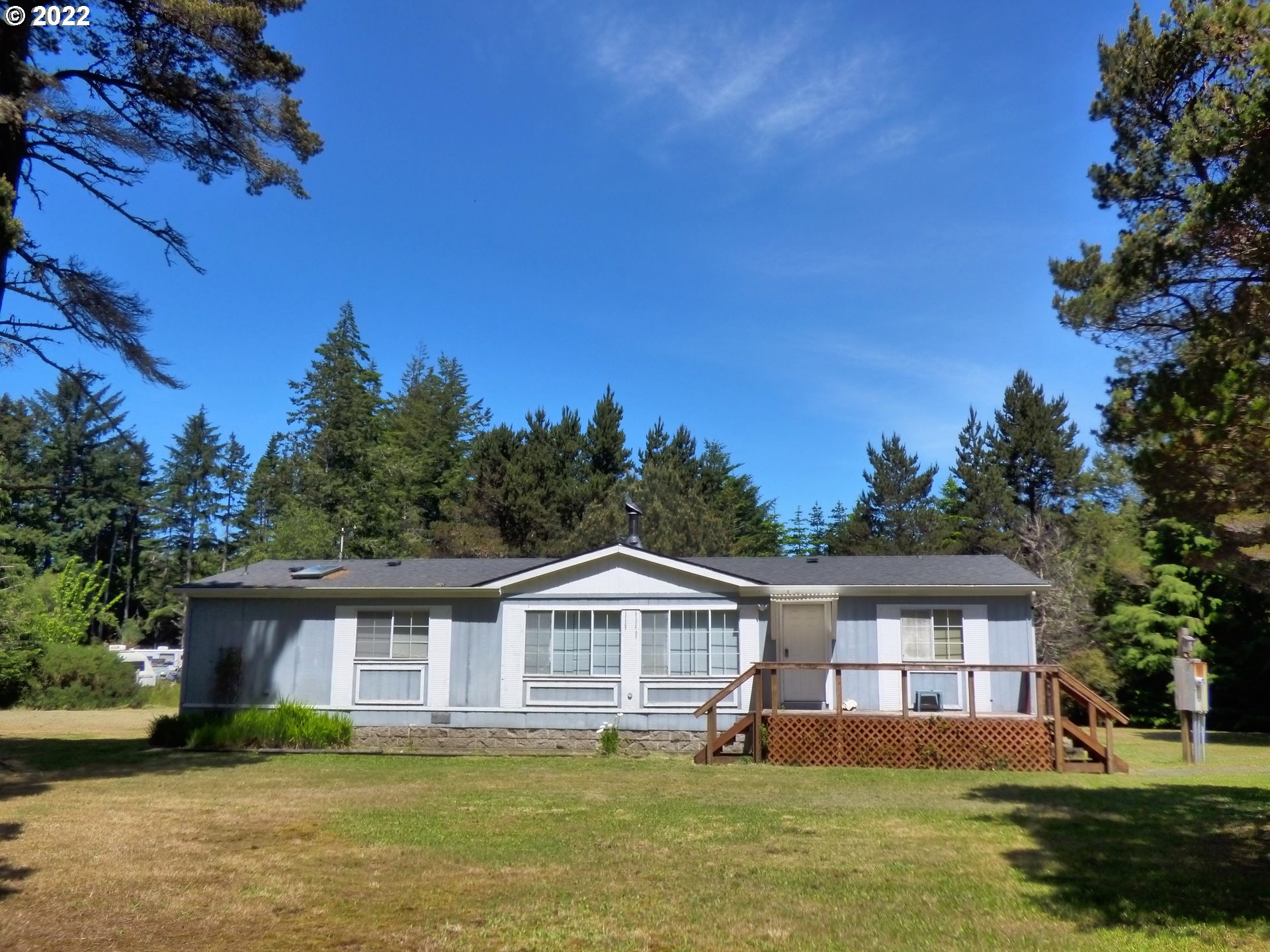 59254 Seven Devils Road Bandon, OR 97411 - Photo 3 of 31 a front view of a house with a garden