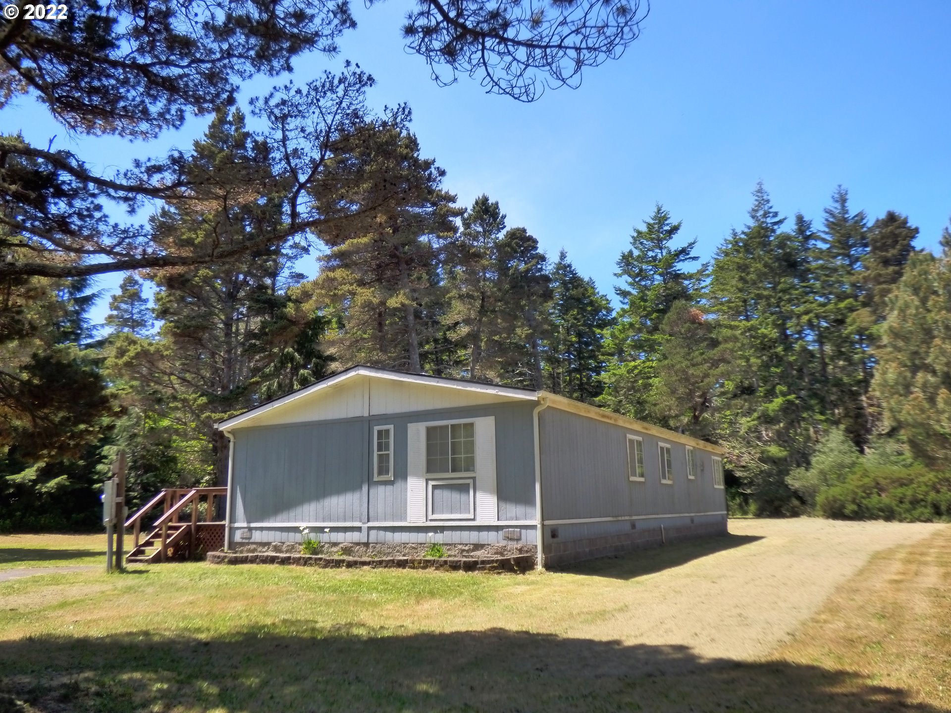 59254 Seven Devils Road Bandon, OR 97411 - Photo 4 of 31 a house with trees in the background