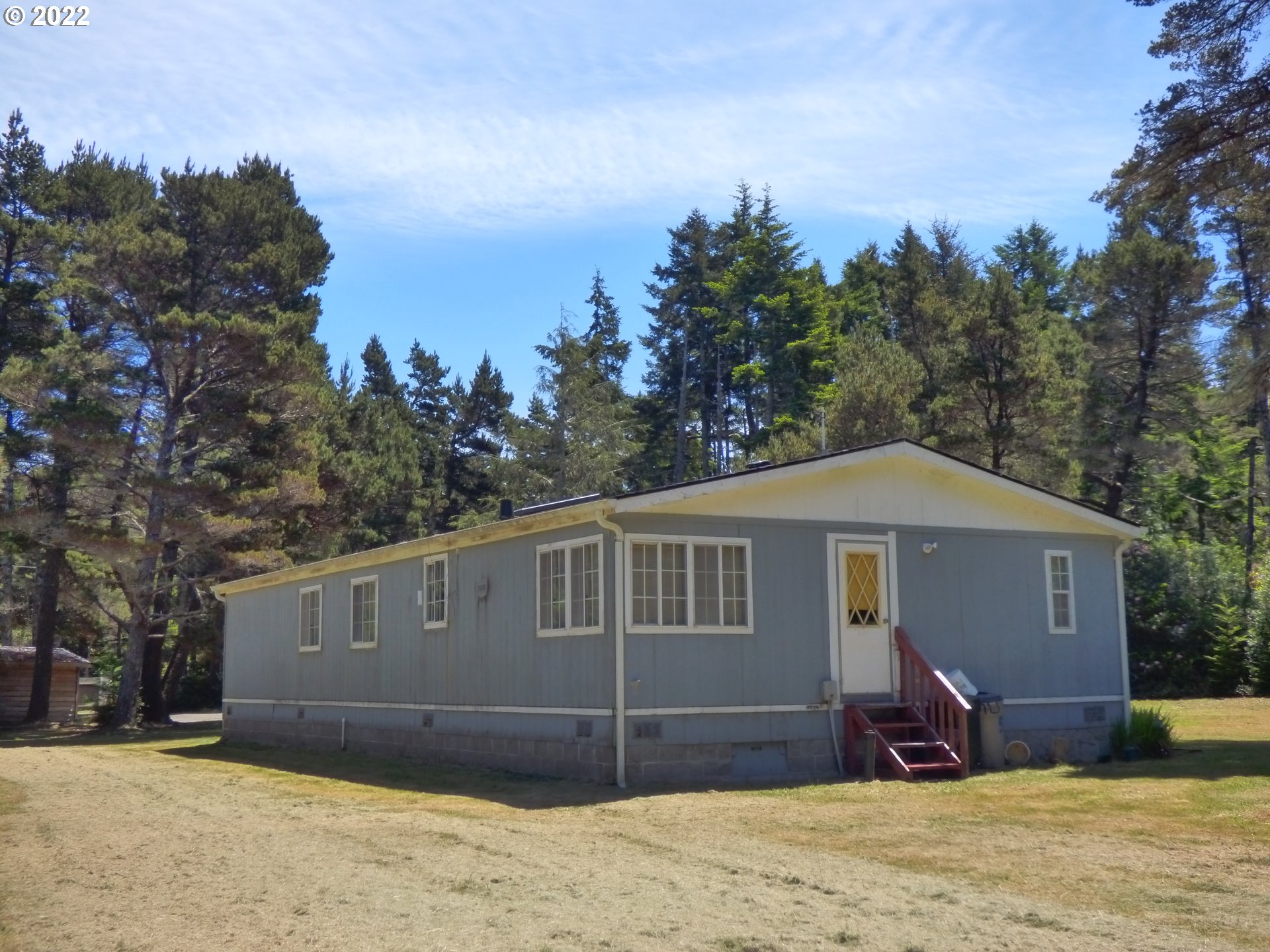59254 Seven Devils Road Bandon, OR 97411 - Photo 5 of 31 a front view of a house with a yard