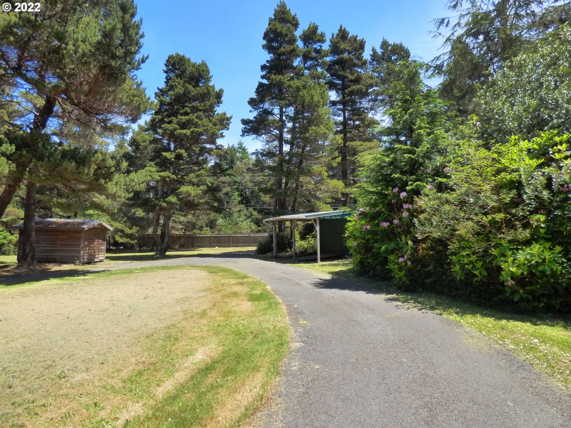 59254 Seven Devils Road Bandon, OR 97411 - Photo 9 of 31 a backyard of a house with yard and entertaining space