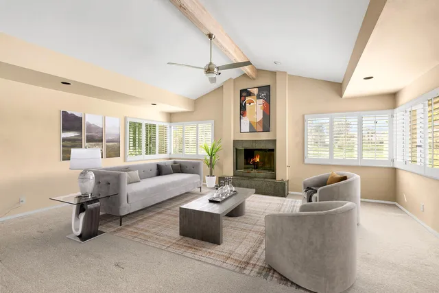 a view of a living room with furniture and a large window