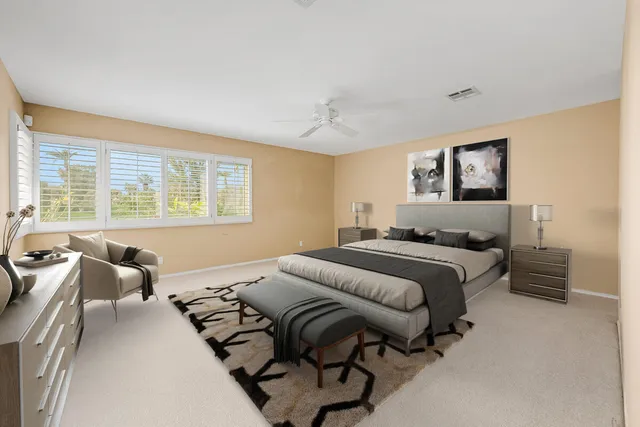 an empty room with a ceiling fan and closet area