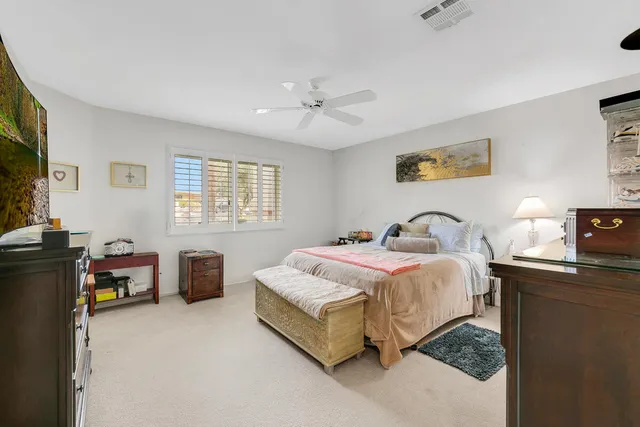 a spacious bathroom with a granite countertop sink and a mirror