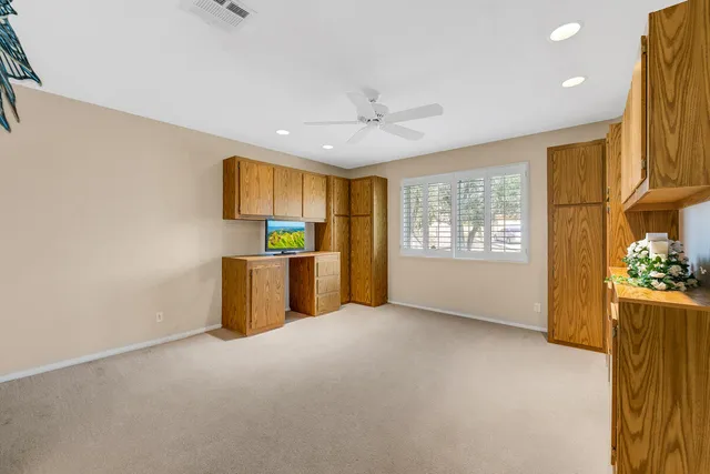 a spacious bathroom with a sink a toilet a mirror and shower