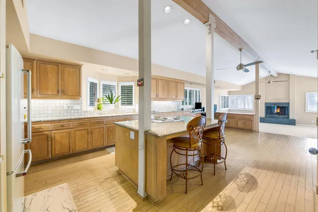 a view of a house with a yard and large trees