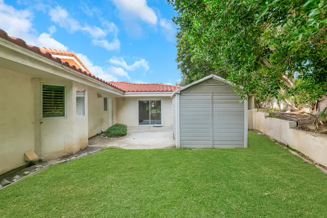 a view of a house with a backyard porch and sitting area