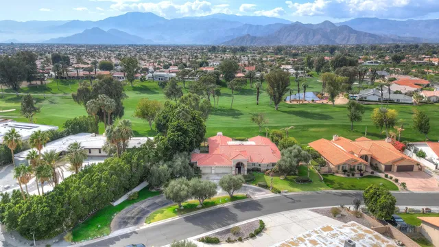 an aerial view of residential houses with yard and lake view