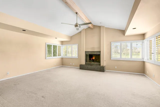 a living room with furniture large window and a fireplace