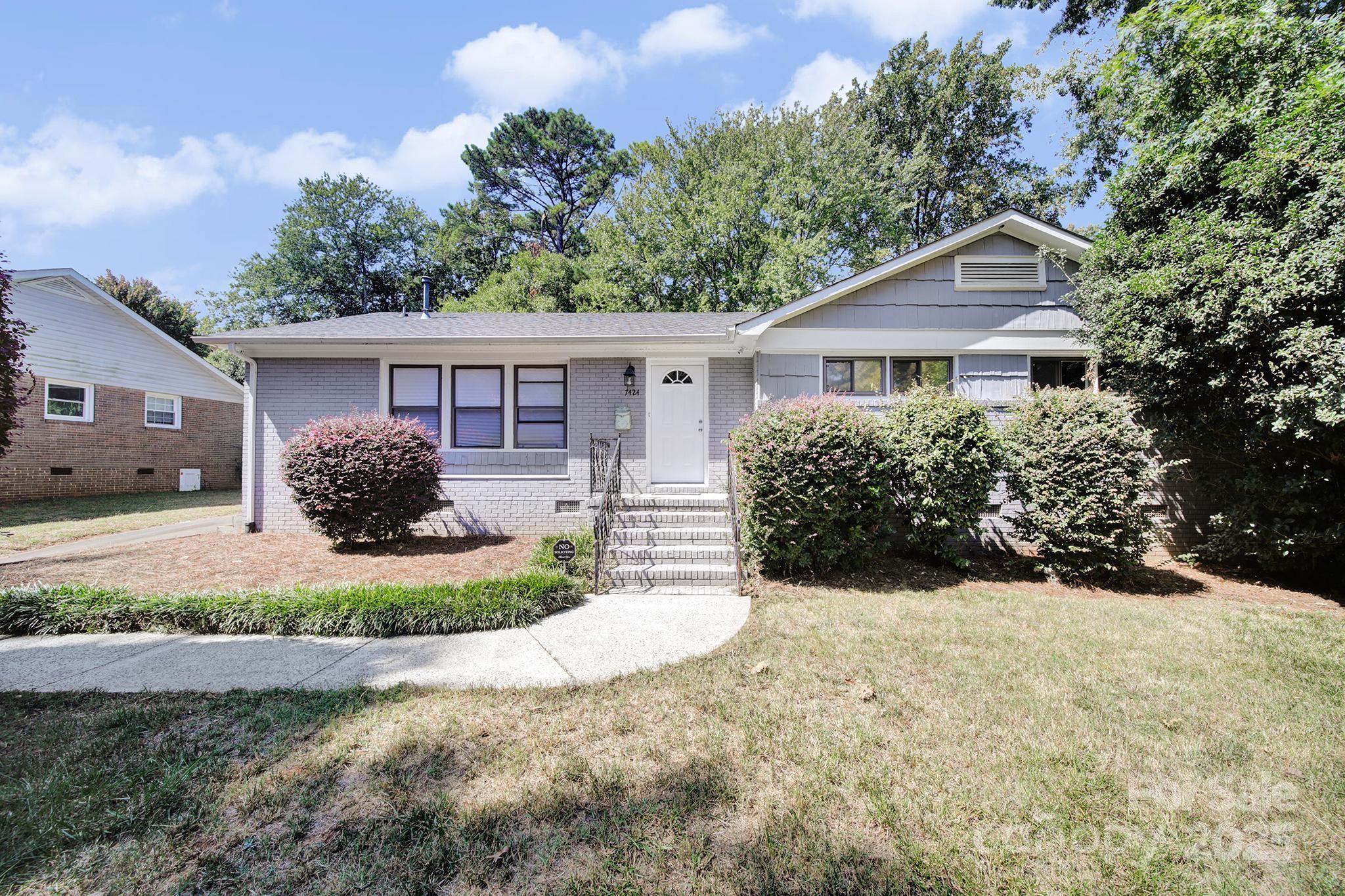 7424 Watercrest Road Charlotte, NC 28210 - Photo 1 of 32 a view of a house with a yard and potted plants