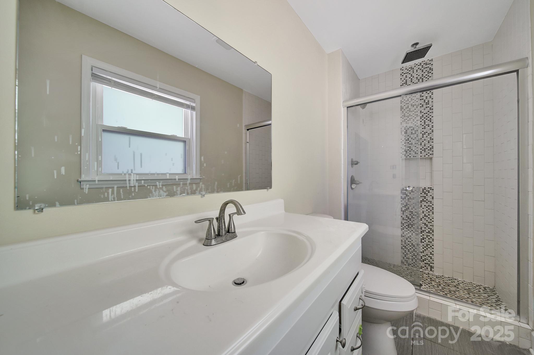 7424 Watercrest Road Charlotte, NC 28210 - Photo 21 of 32 a bathroom with a sink toilet and shower