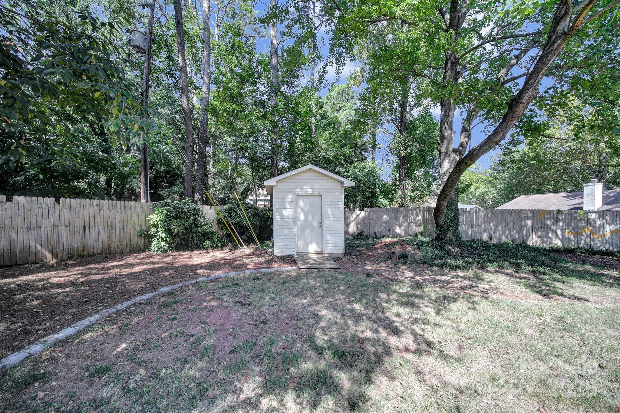 7424 Watercrest Road Charlotte, NC 28210 - Photo 24 of 32 a backyard of a house with lots of green space